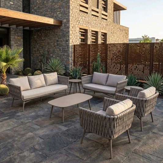Outdoor sofa set with gray cushions, woven chairs, and round coffee table