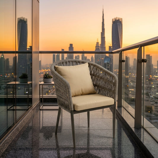 Outdoor woven rope dining chair with beige seat cushion and dark gray legs