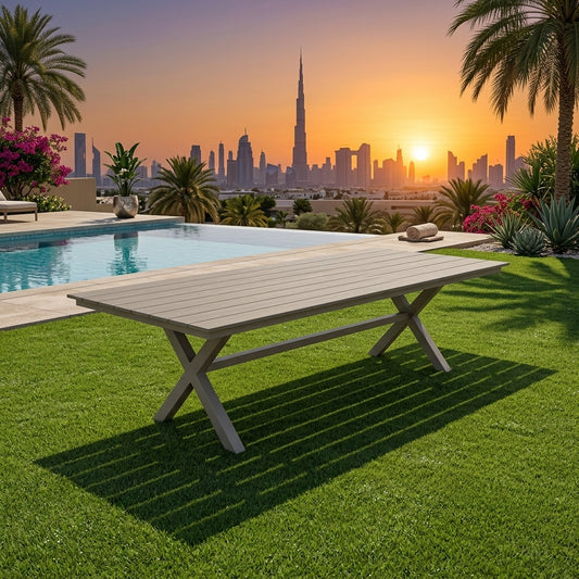 Rectangular aluminum outdoor dining table with light gray slatted top and X-frame legs