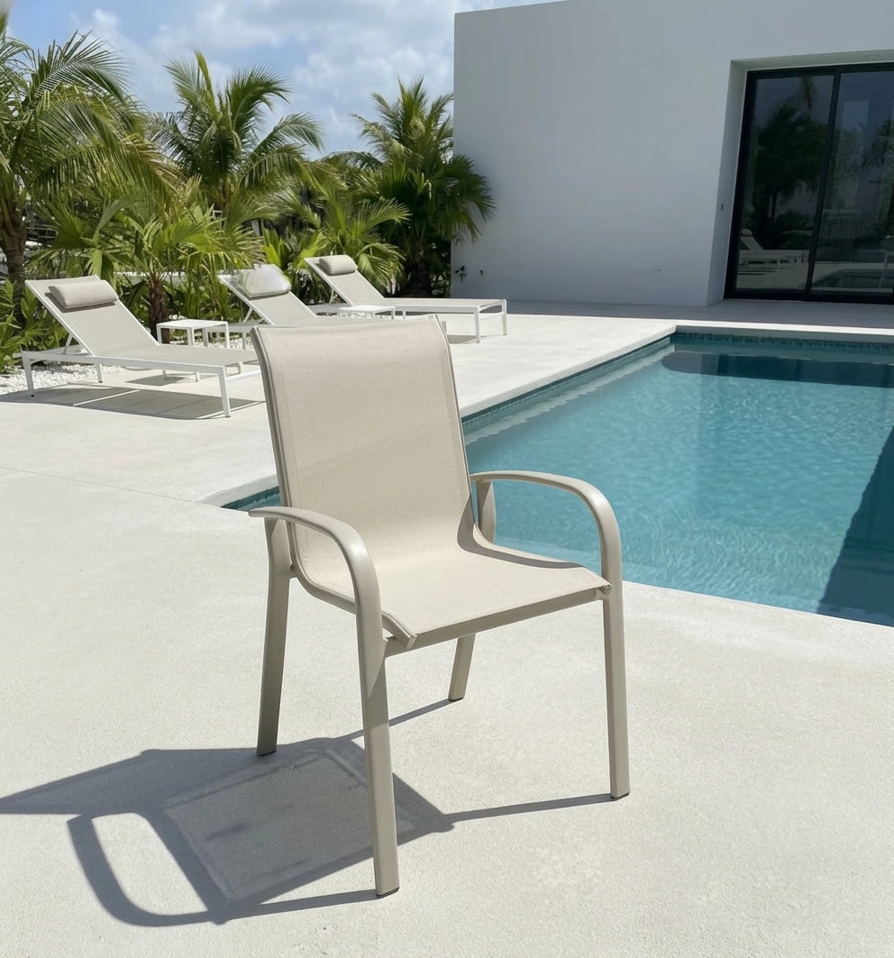 Light gray aluminum outdoor armchair with curved armrests and mesh seat/back